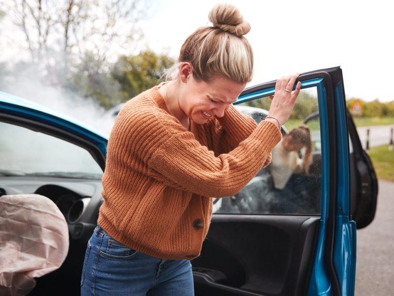 Female Motorist In Crash For Crash Insurance Fraud Getting Out Of Car