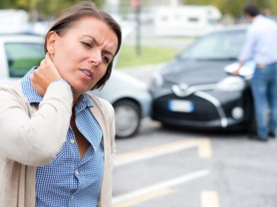 woman holding neck car accident chiropractor