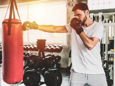 Portrait sporty men with the back boxing gloves training at the gym