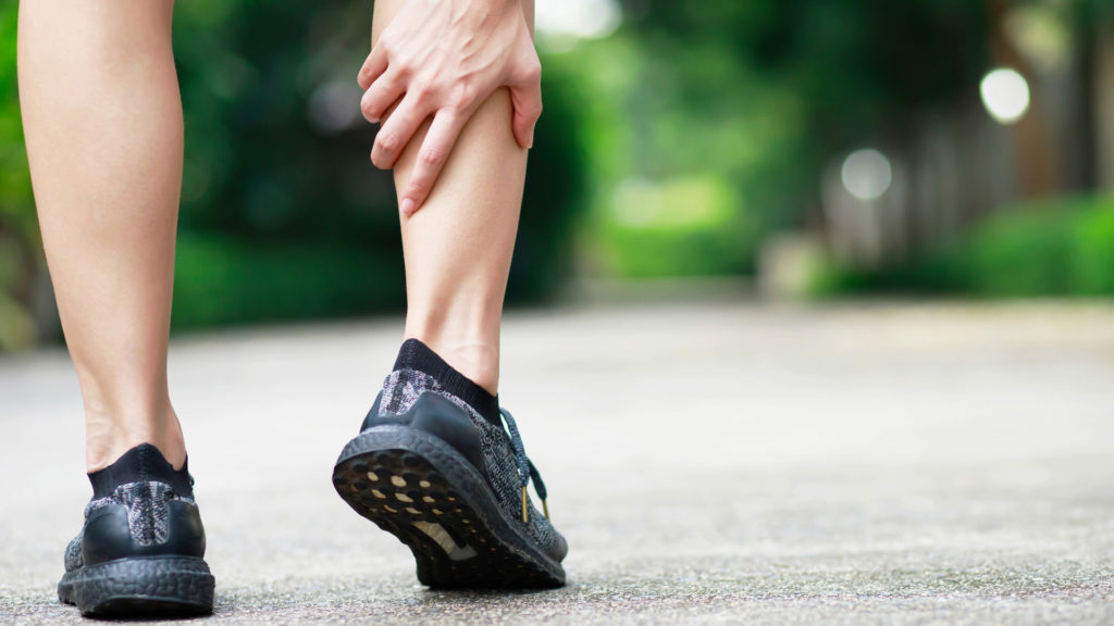 Runner experiencing calf pain wondering when you should visit a chiropractor.