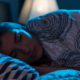Woman sleeping in blue background light