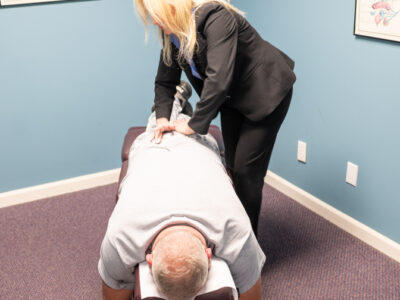 chiropractor adjusting patient with lower back pain