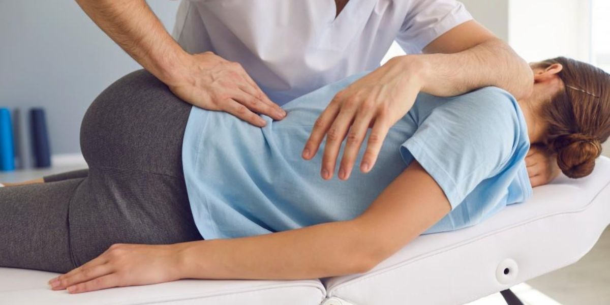 Chiropractor evaluating a patient with degenerative disc disease and providing spinal care treatment | Chiropractor in Managing Degenerative Disc Disease
