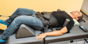 Patient receiving spinal decompression therapy on a specialized treatment table at a chiropractic clinic | How Long Does It Take To See Results From Spinal Decompression Therapy