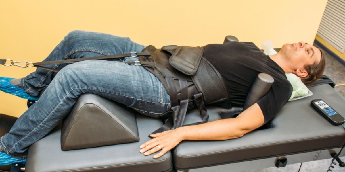 Patient receiving spinal decompression therapy on a specialized treatment table at a chiropractic clinic | How Long Does It Take To See Results From Spinal Decompression Therapy