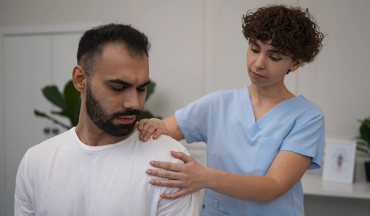 A chiropractor examining a patient's shoulder and neck area for thoracic outlet syndrome treatment.