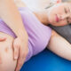 A pregnant woman lying comfortably while receiving gentle chiropractic care to support spine alignment and promote a healthy pregnancy.